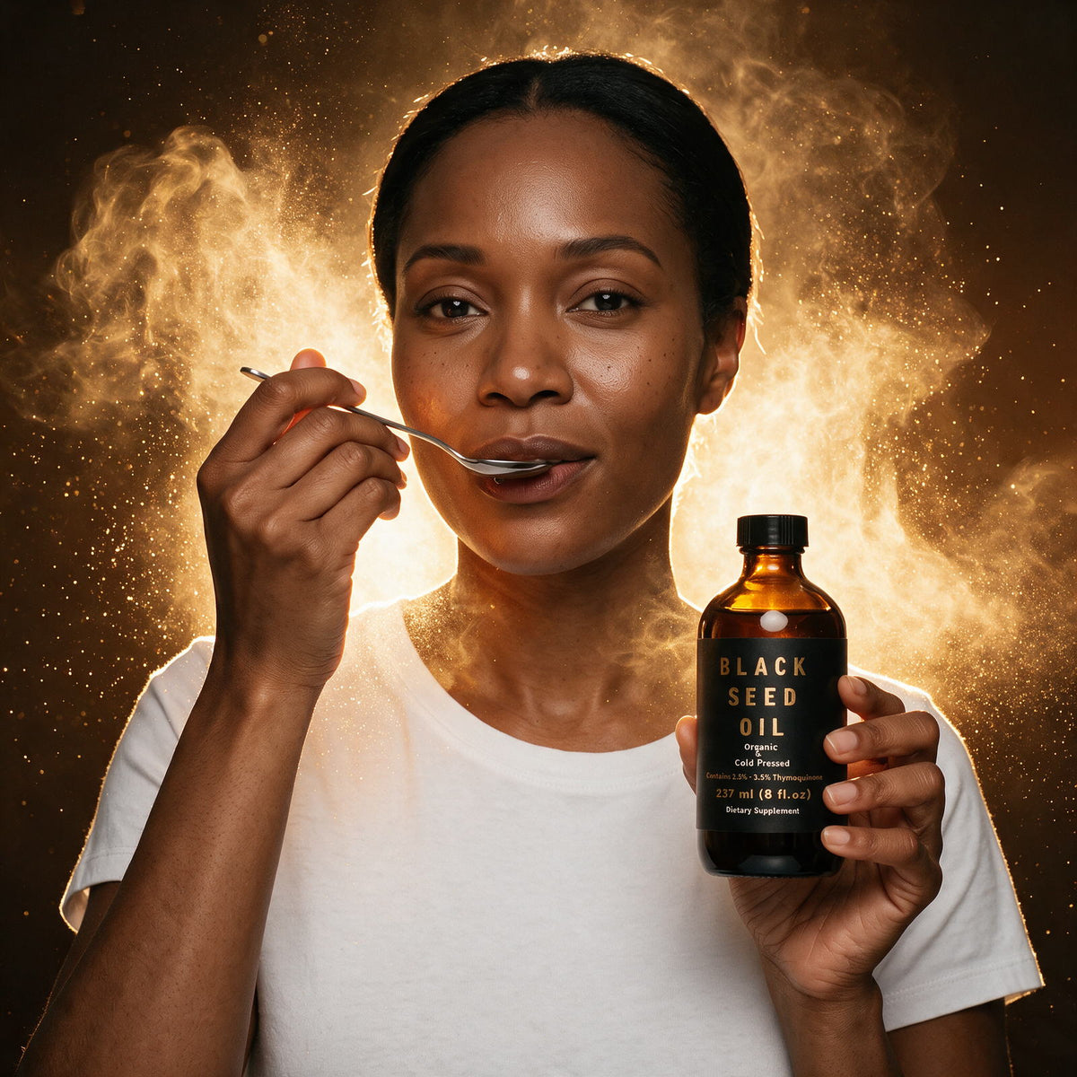 Woman in a white t-shirt taking a spoonful of Farmacy For Life Black Seed Oil while holding the bottle, surrounded by golden mist